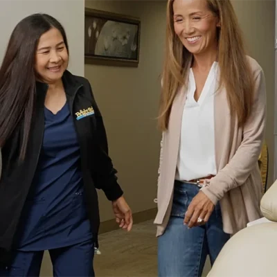 Bright Side Dental staff member walking into a room with a patient.